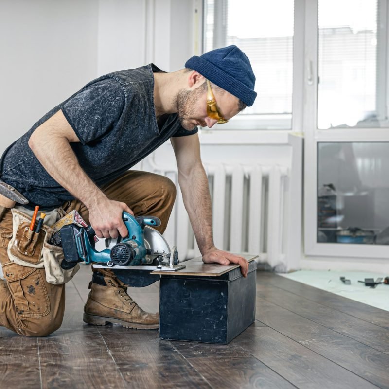 Circular Saw, carpenter using a circular saw for wood.
